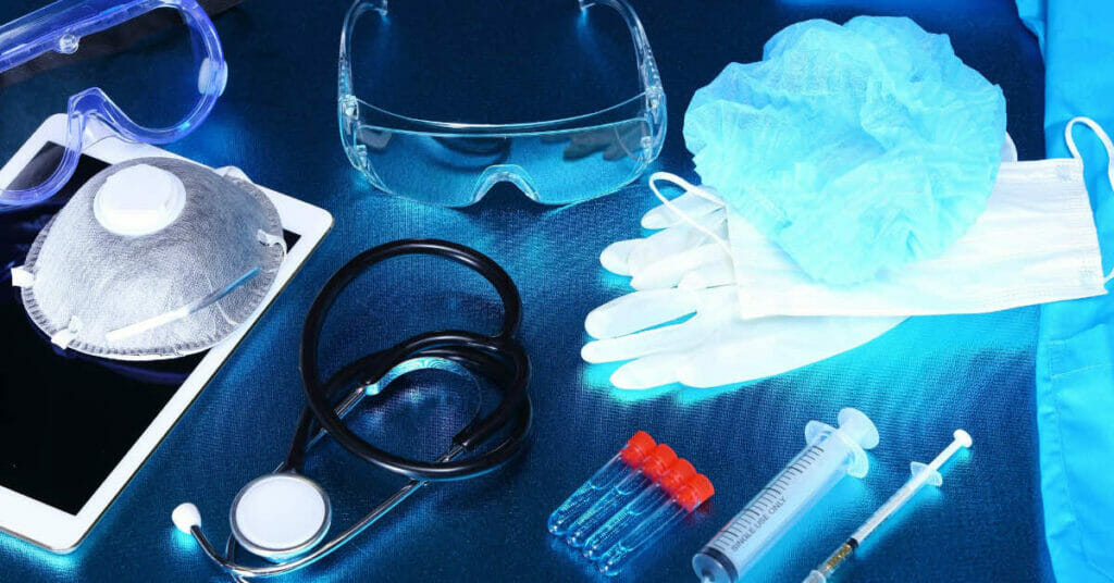Medical equipment and medical supplies on a blue table emphasizing patient safety through infection control.